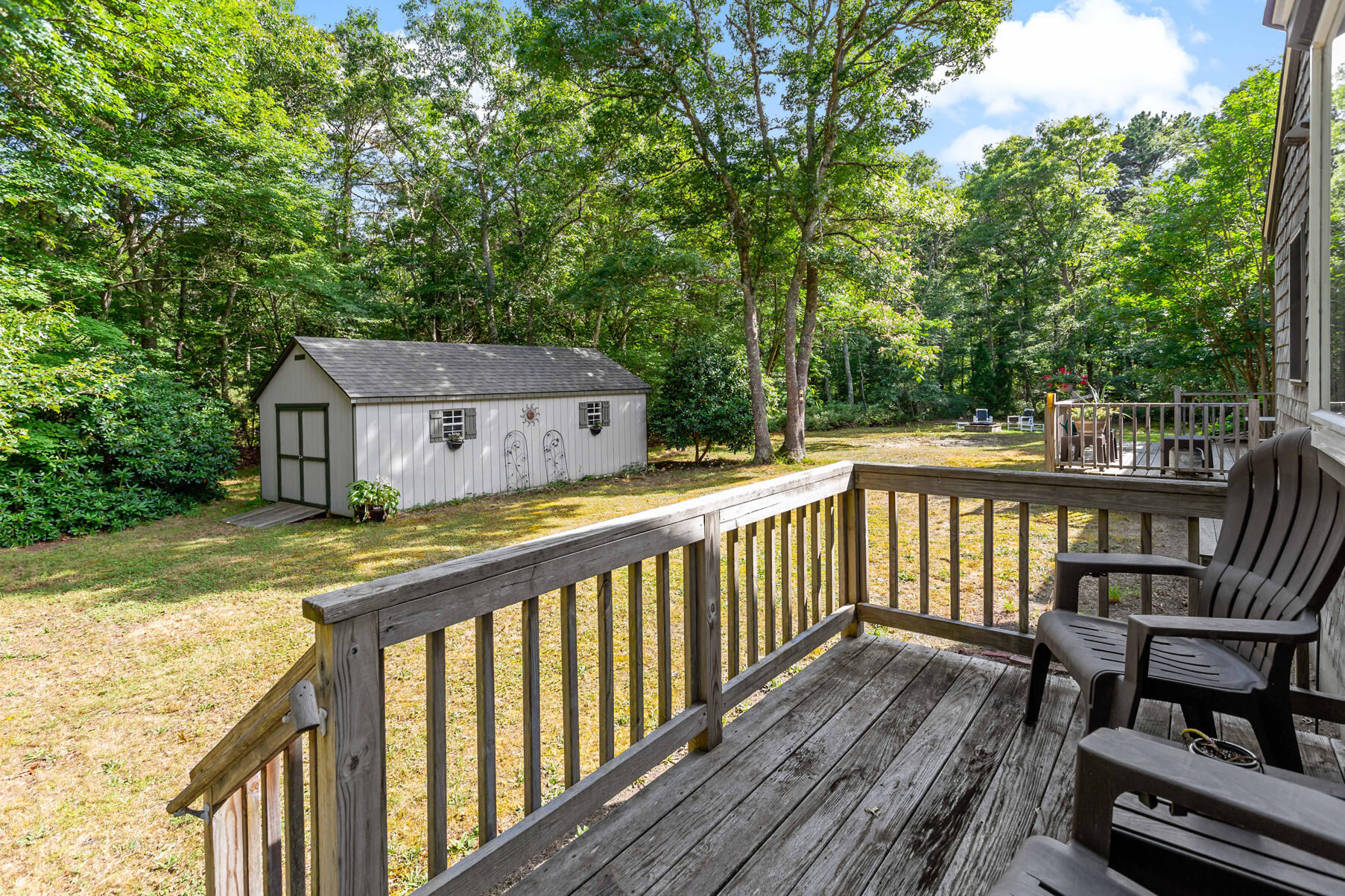 58 Saddleback Road Mashpee, MA 02649 - Photo 33 of 40 a view of a wooden deck and a yard