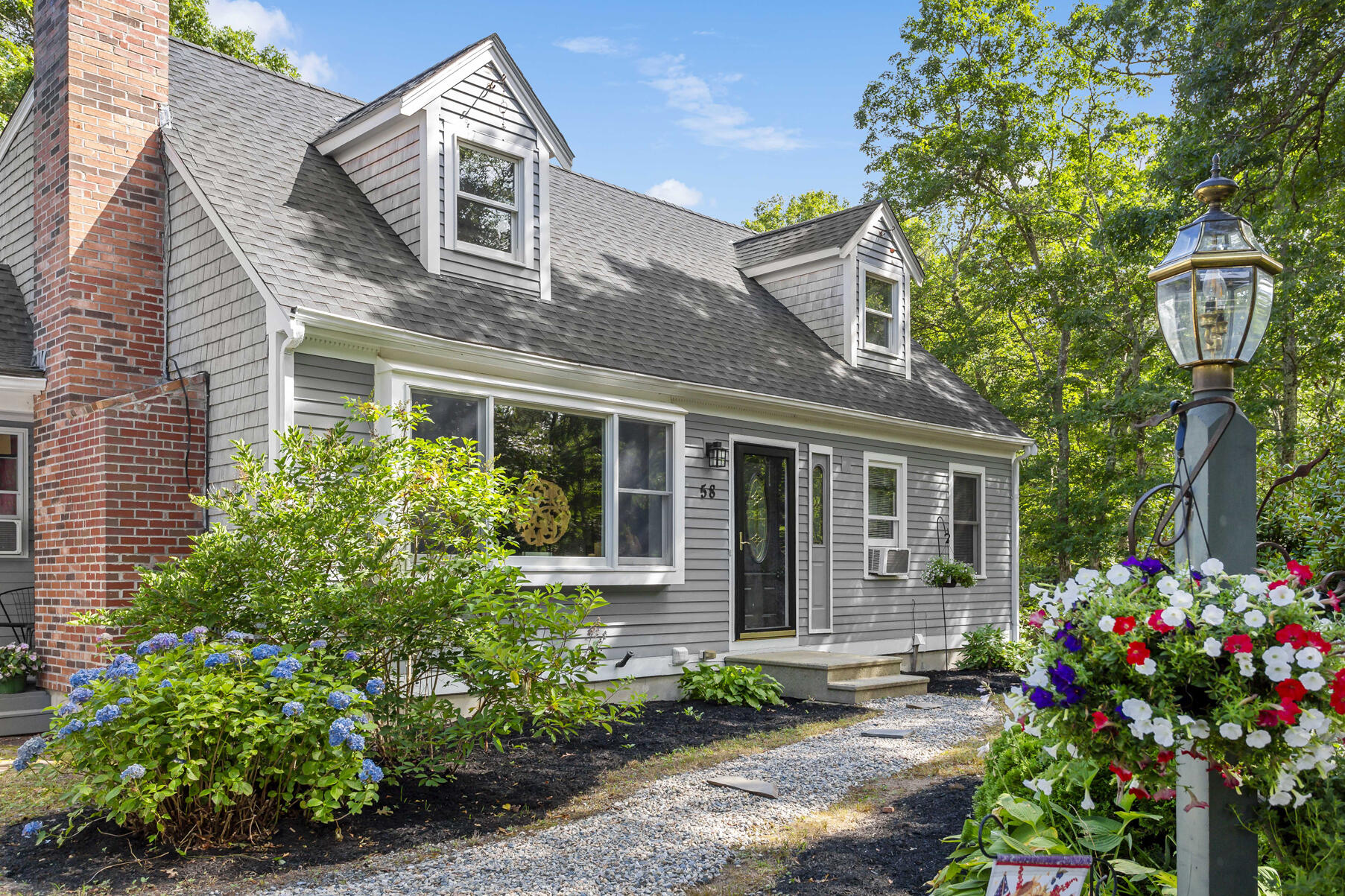 58 Saddleback Road Mashpee, MA 02649 - Photo 4 of 40 a front view of a house with a garden