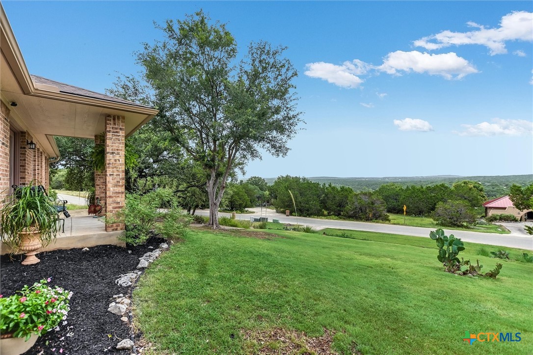 60 Crazy Cross Road Wimberley, TX 78676 - Photo 2 of 20 A welcoming front porch and landscaping with view.