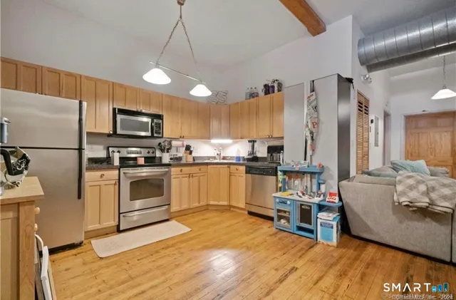 a kitchen with a sink stainless steel appliances and white cabinets
