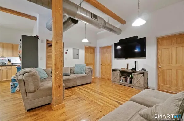 a living room with furniture and a flat screen tv