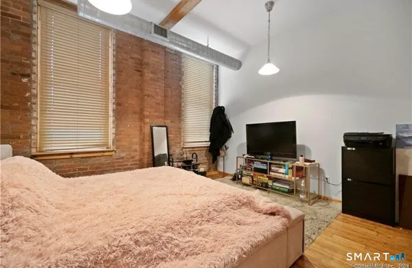 a bedroom with a bed and a flat screen tv