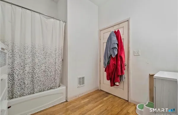 a view of a room with lots of stuff and shower curtain