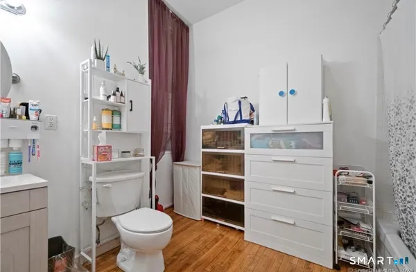 a bathroom with a toilet sink and mirror