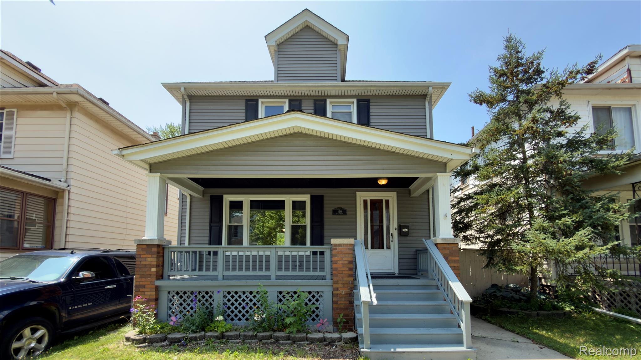 130 Elm Street River Rouge, MI 48218 - Photo 2 of 20 Two-story residential structure featuring gray siding and black shutters