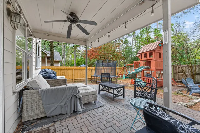 a outdoor sitting area with furniture and wooden floor