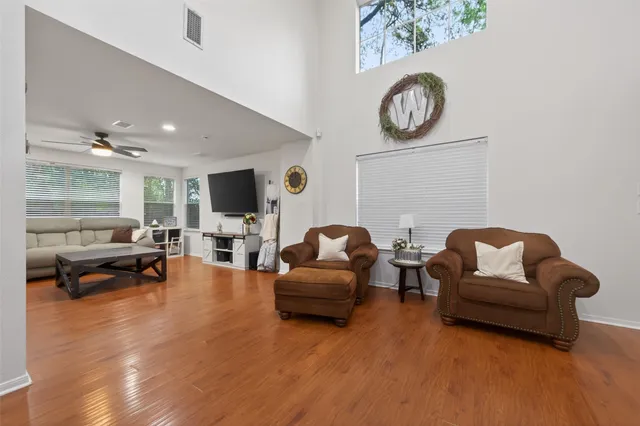 a living room with furniture and a wooden floor