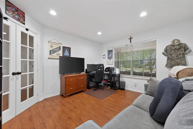a bedroom with furniture and a flat screen tv