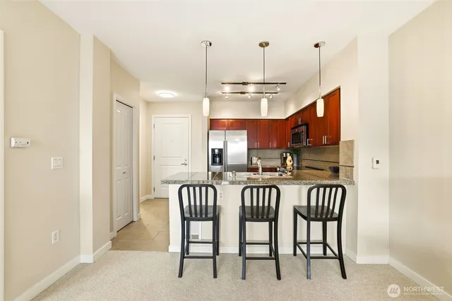 a dining room with furniture potted plants and wooden floor