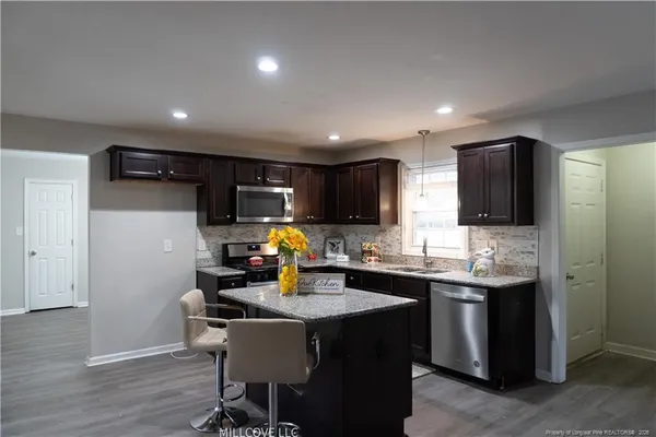 a kitchen with sink cabinets and dining table