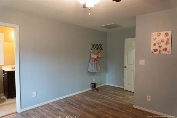 a view of a room with wooden floor and closet