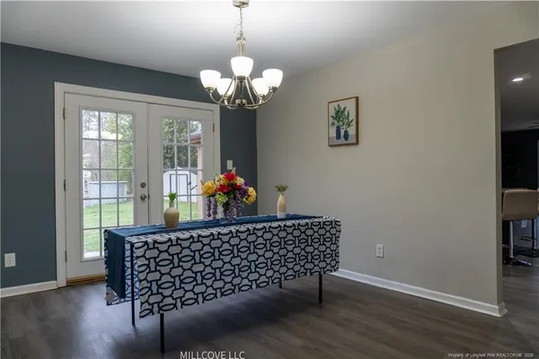 a room with furniture wooden floor and a chandelier
