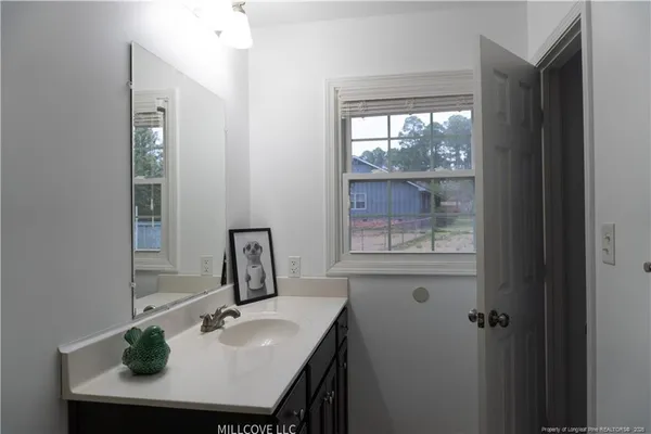 a bathroom with a tub shower and sink