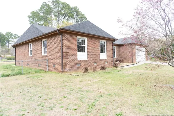 a view of a house with a yard and garage