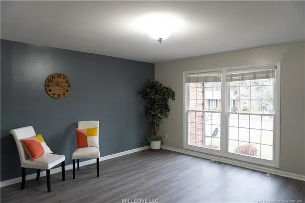 wooden floor in a room next to a window