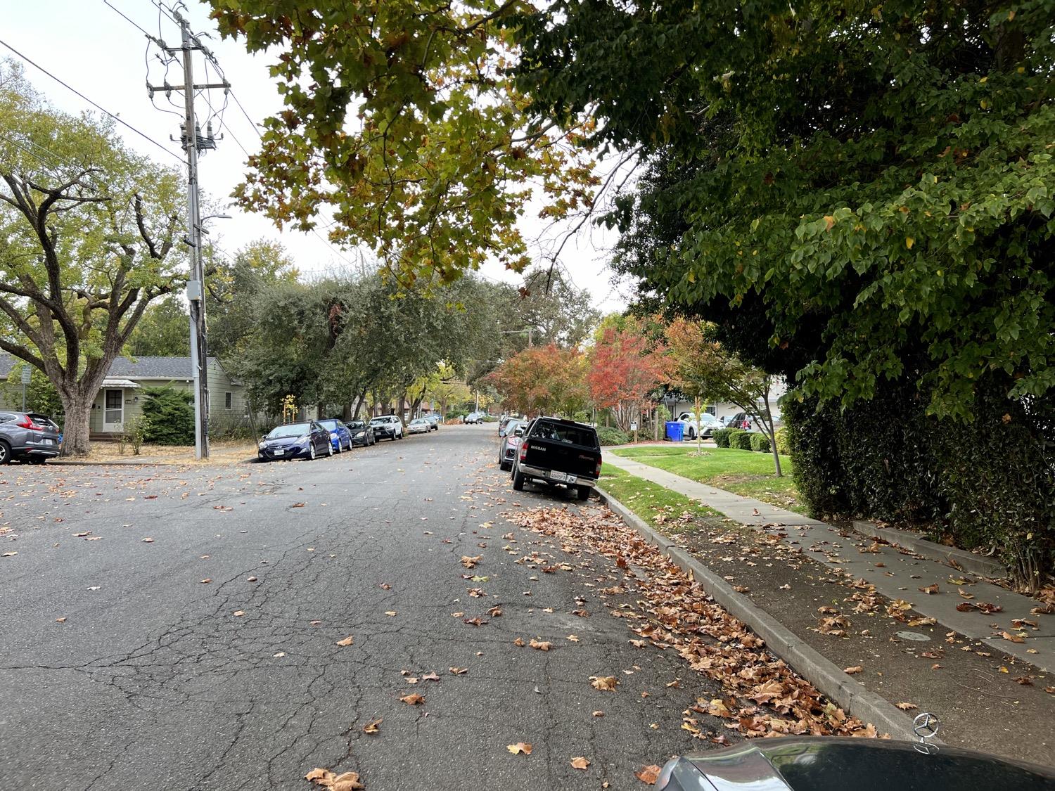 a view of street with parked cars
