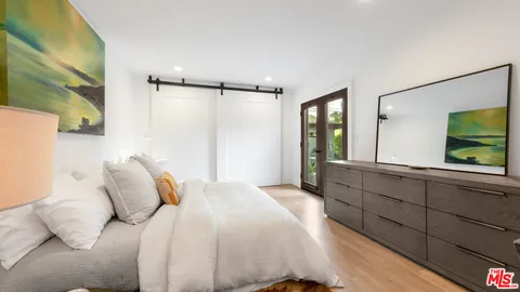 a bedroom with a large bed and a large window