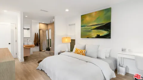 a bedroom with a bed and flat screen tv