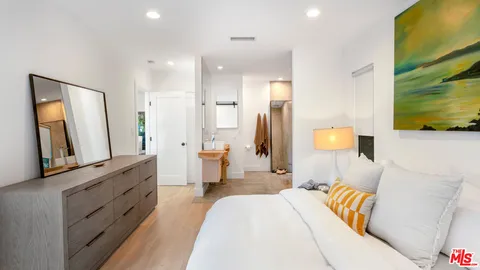 a spacious bedroom with a bed and a couch