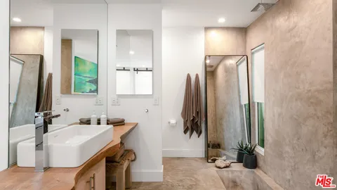 a bathroom with a double vanity sink and a mirror