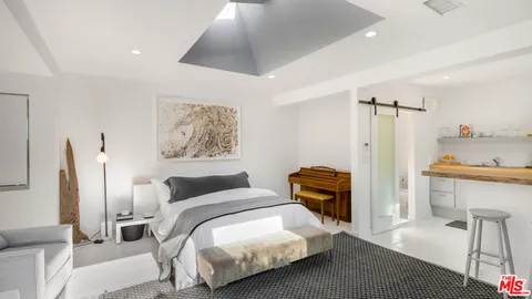 a bedroom with a large bed and a couch