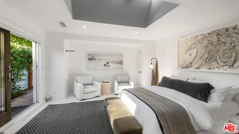 a bedroom with a bed and flat tv screen