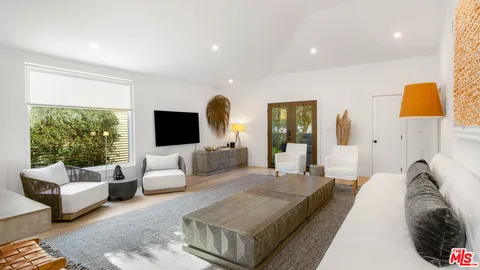 a spacious bedroom with a bed and couch