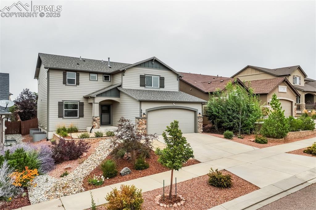 3410 Daydreamer Drive Colorado Springs, CO 80908 - Photo 1 of 50 a front view of a house with garden