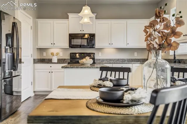a kitchen with a appliances and cabinets
