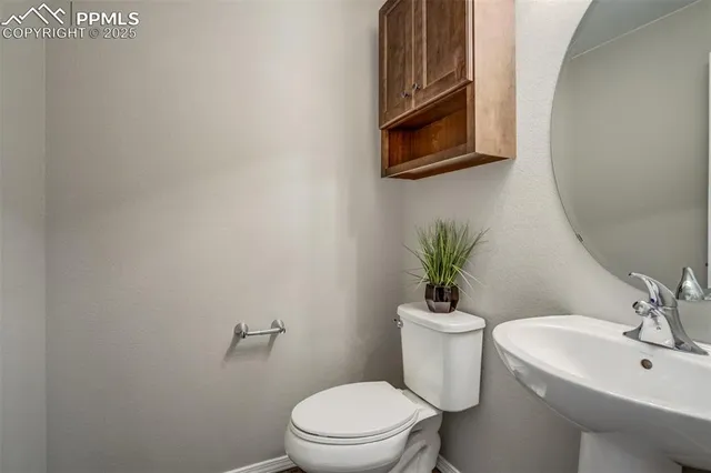 a bathroom with a sink mirror and toilet