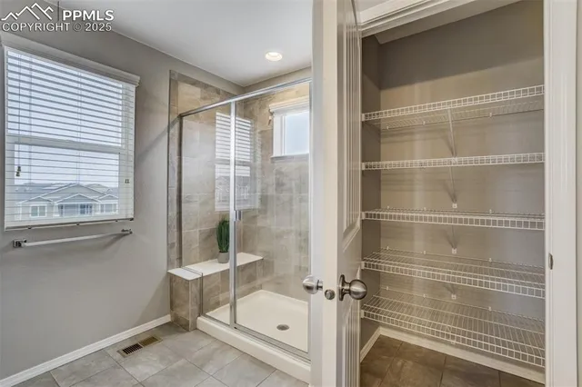 a bathroom with a glass shower door