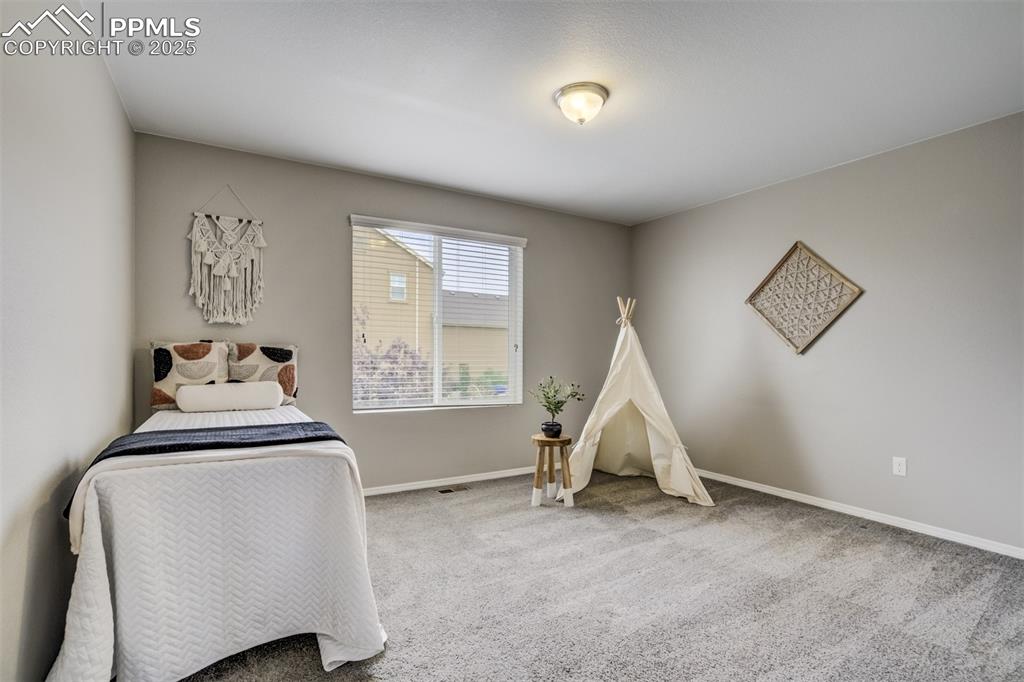 3410 Daydreamer Drive Colorado Springs, CO 80908 - Photo 31 of 50 a room with a bed and a window