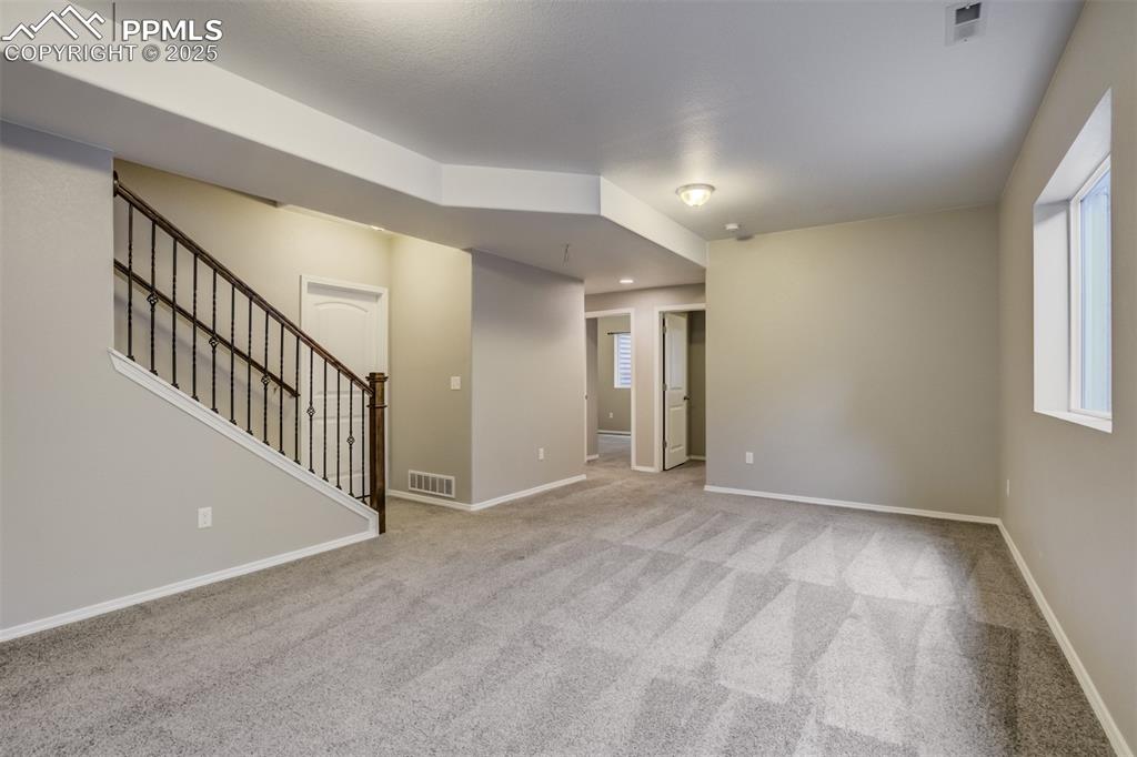 3410 Daydreamer Drive Colorado Springs, CO 80908 - Photo 39 of 50 a view of an empty room with wooden floor and windows