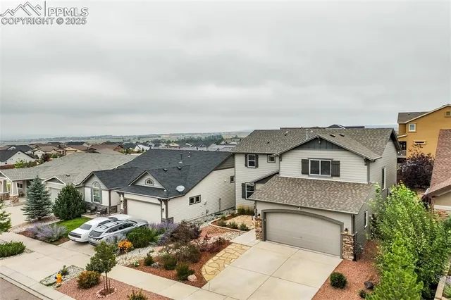 an aerial view of a house with a yard