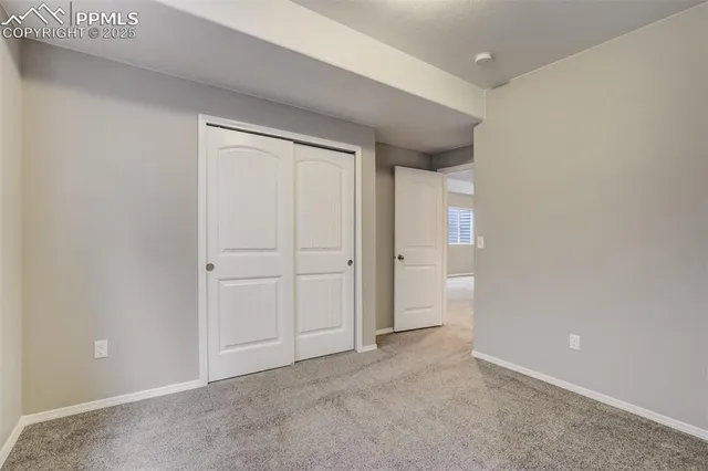 a view of an empty room and closet area