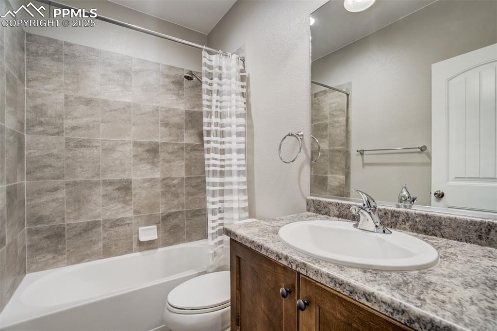 3410 Daydreamer Drive Colorado Springs, CO 80908 - Photo 44 of 50 a bathroom with a granite countertop sink toilet and shower