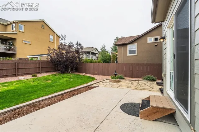 a view of backyard with wooden fence