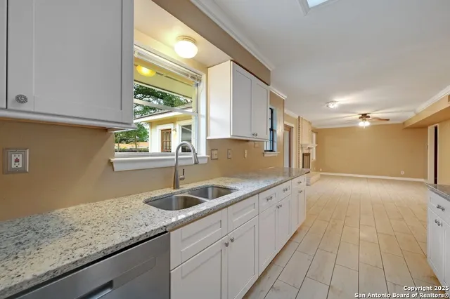 a kitchen with granite countertop a sink and a window