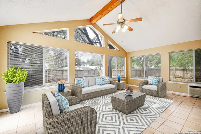 a living room with furniture and a large window
