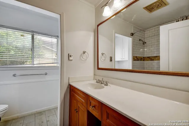 a bathroom with a sink a vanity and a mirror