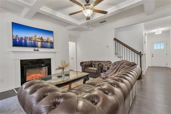 a living room with furniture a fireplace and a flat screen tv