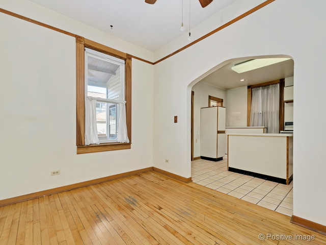 Undisclosed Address Chicago, IL 60613 - Photo 11 of 22 a view of a hallway with wooden floor and a kitchen