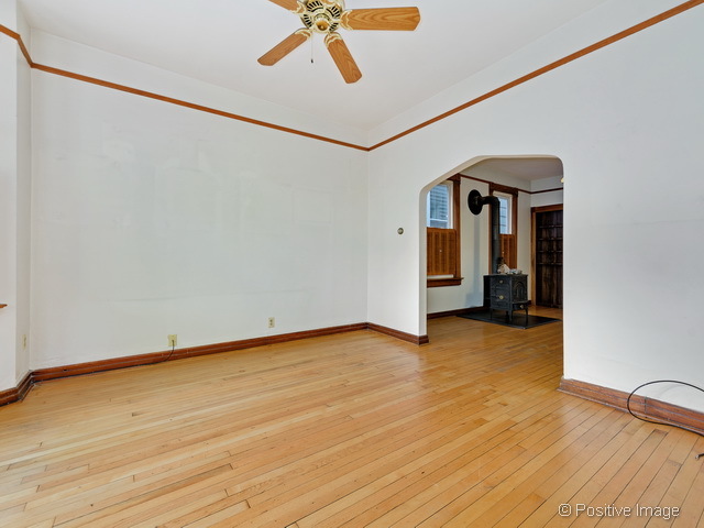 Undisclosed Address Chicago, IL 60613 - Photo 5 of 22 a view of a livingroom with wooden floor and a ceiling fan