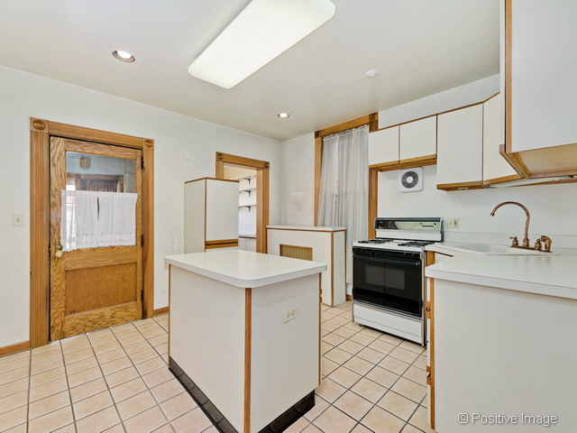 Undisclosed Address Chicago, IL 60613 - Photo 7 of 22 a kitchen with a sink appliances and cabinets