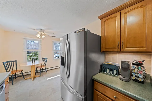 a kitchen with refrigerator and cabinets