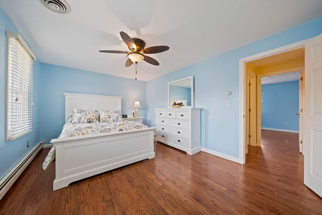 a view of bedroom with furniture and wooden floor