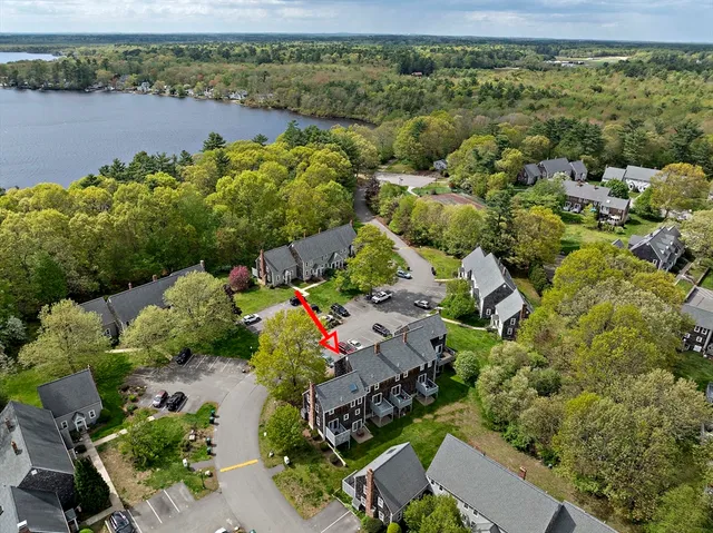 an aerial view of a houses with a lake view