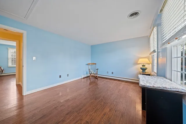 a view of a kitchen with a sink and dishwasher with wooden floor