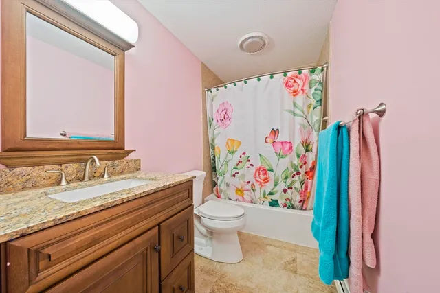 a bathroom with a sink vanity mirror and toilet