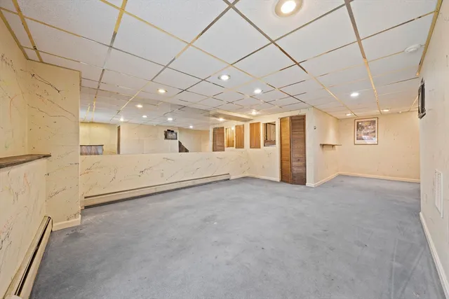 an empty room with a empty space and windows